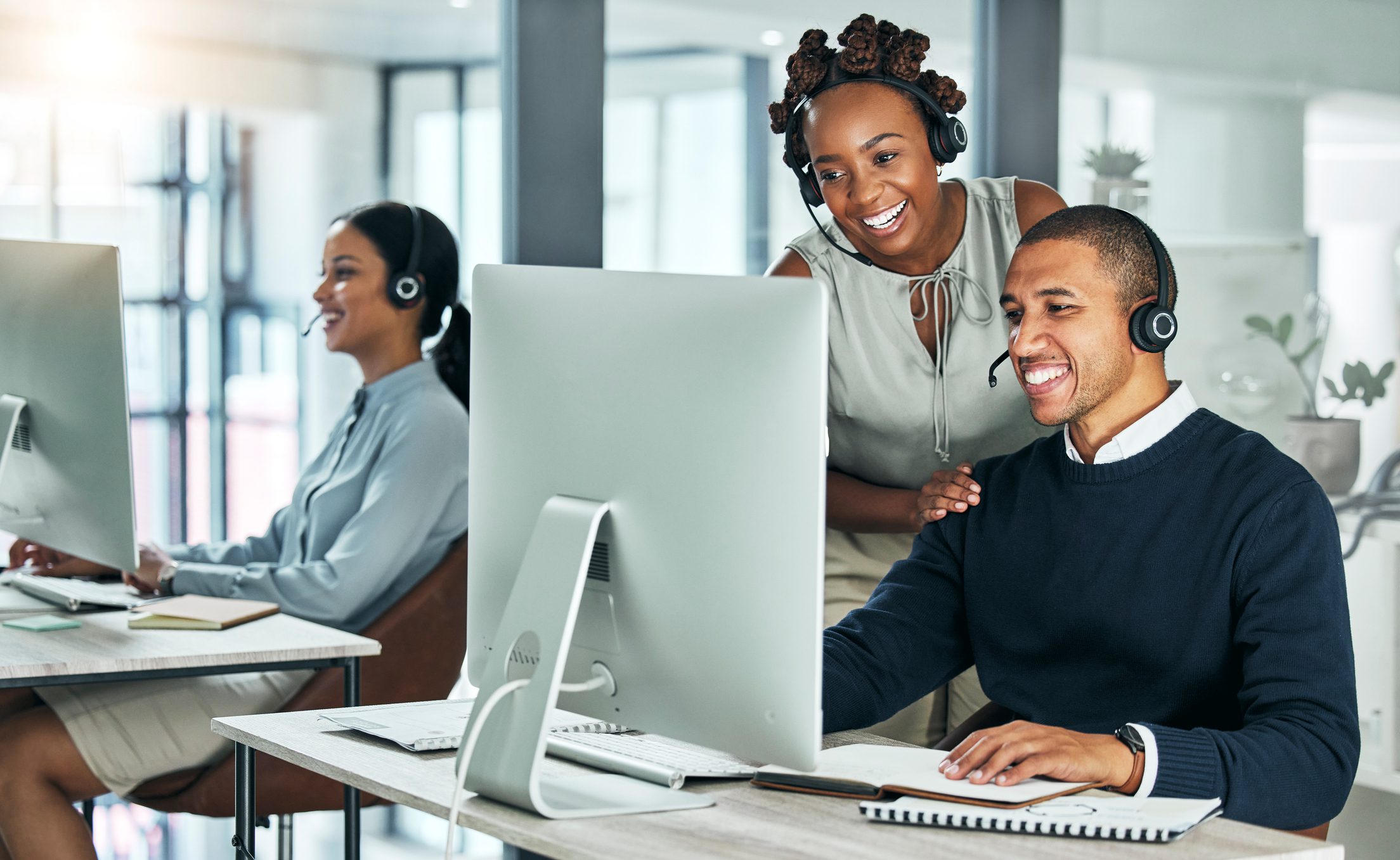 Professionals with headsets in office setting