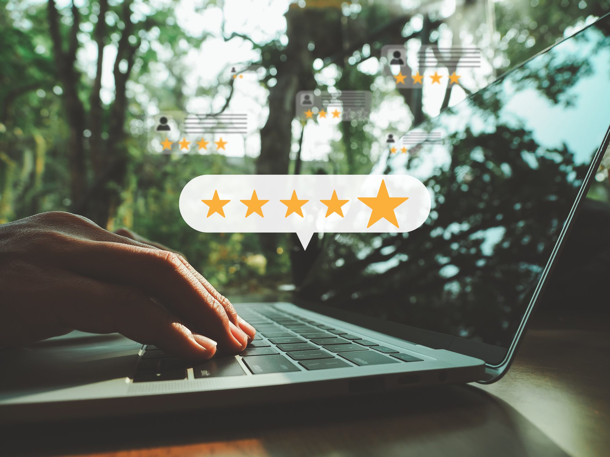 Hand on laptop, five-star feedback