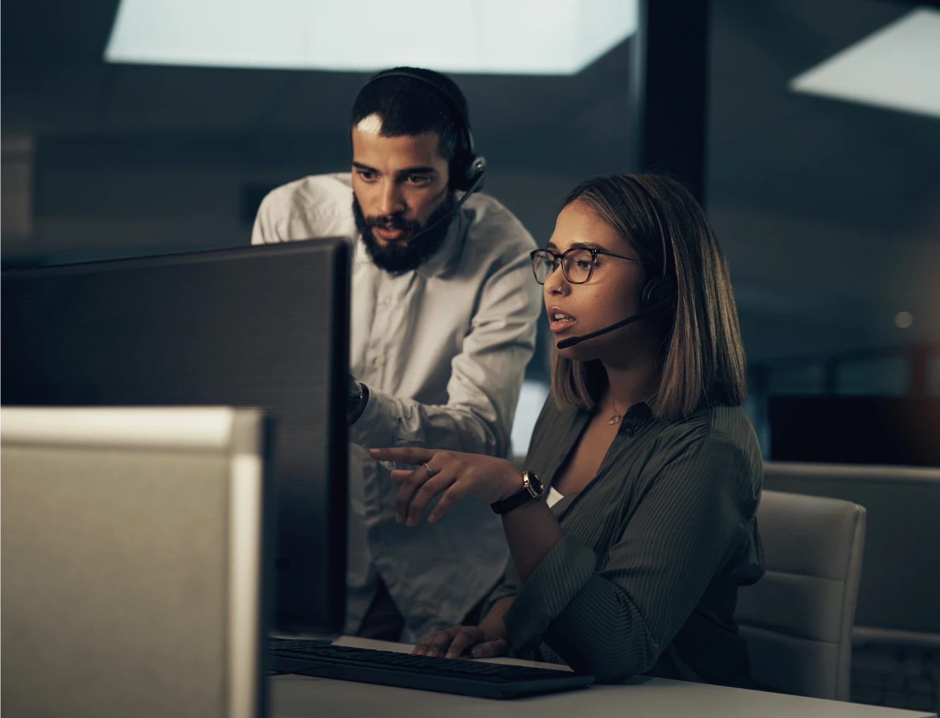 Office workers collaborating at a computer