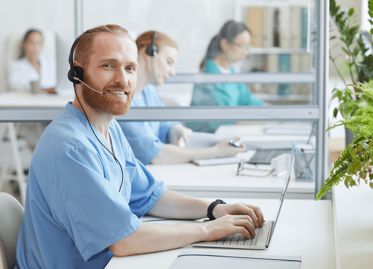 Healthcare worker with headset at desk